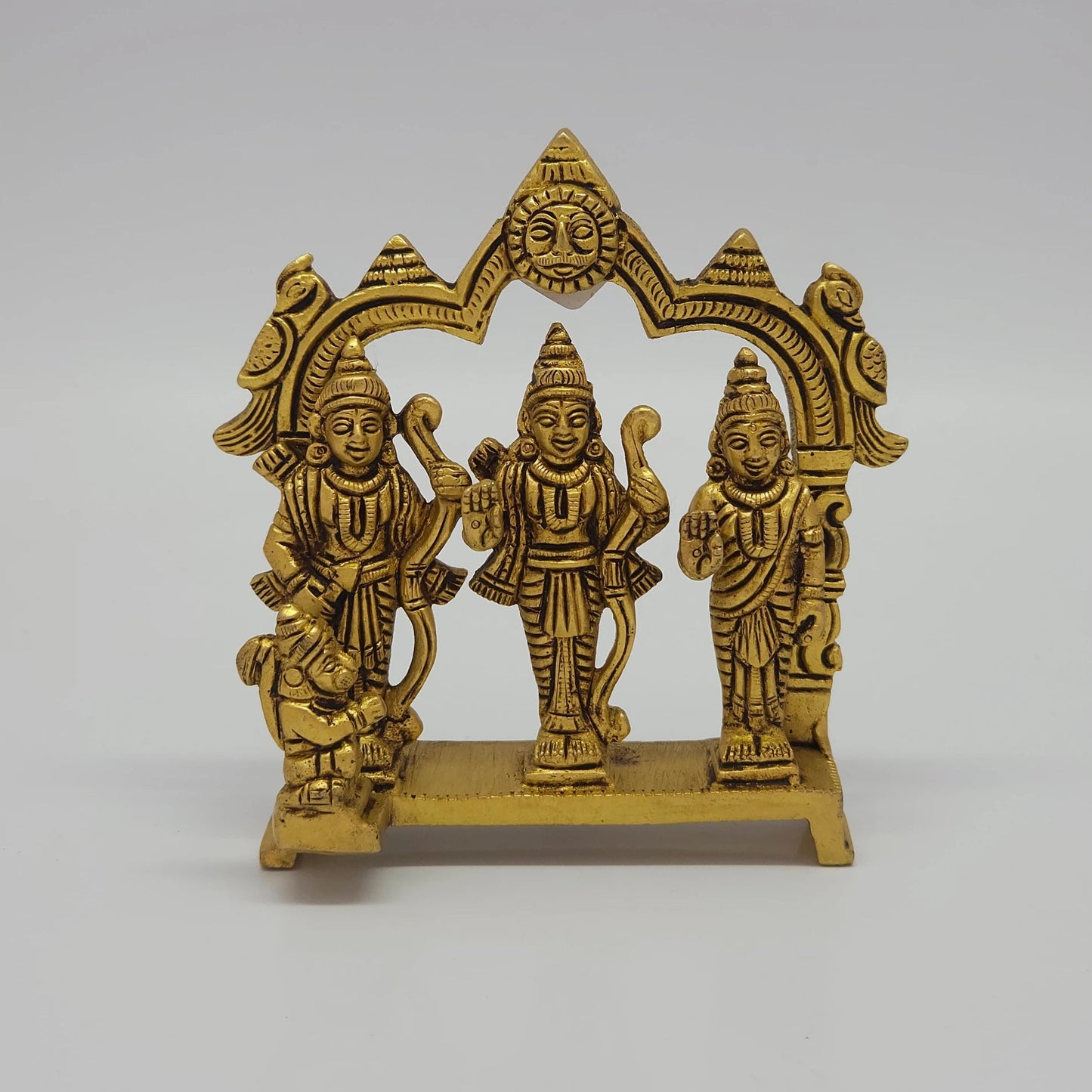 Front view of the 12cm antique solid brass Ram Darbar statue with Rama, Sita, Lakshmana, and Hanuman under a temple arch for Rama Navami puja.