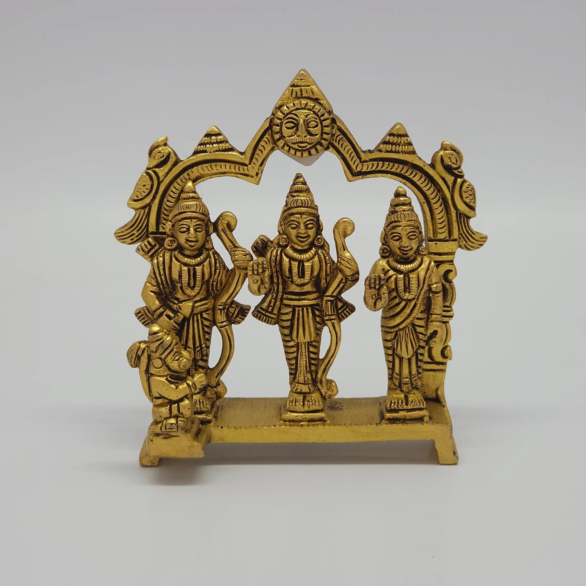 Front view of the 12cm antique solid brass Ram Darbar statue with Rama, Sita, Lakshmana, and Hanuman under a temple arch for Rama Navami puja.