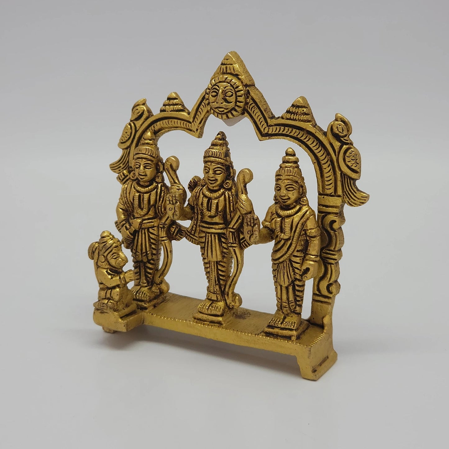 Left 45-degree angle profile emphasizing the detailed kneeling Hanuman pose, Lakshmana's bow, and the raised bench base legs.
