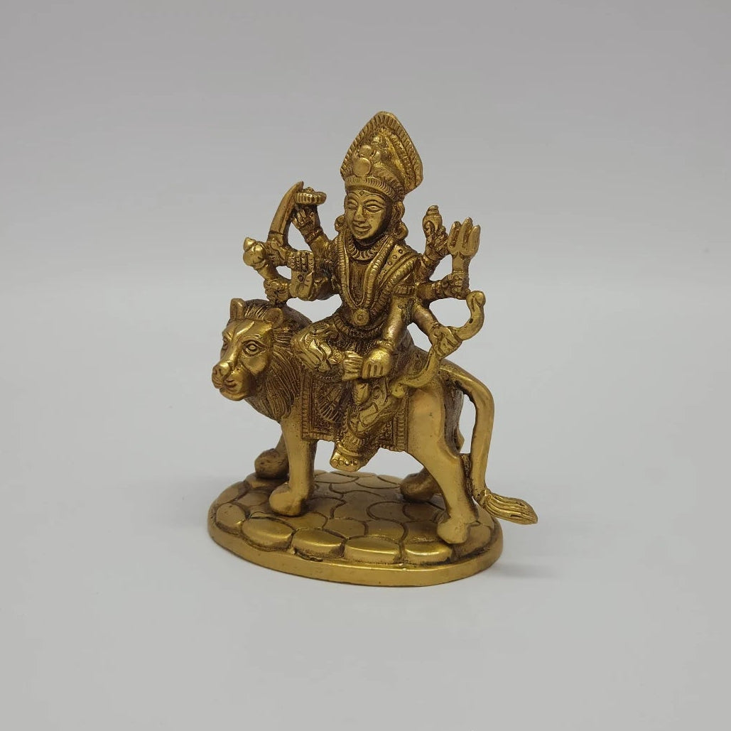 Left 45-degree angle profile emphasizing the detailed lion mane, the weapons held in the left hands, and the textured base lines