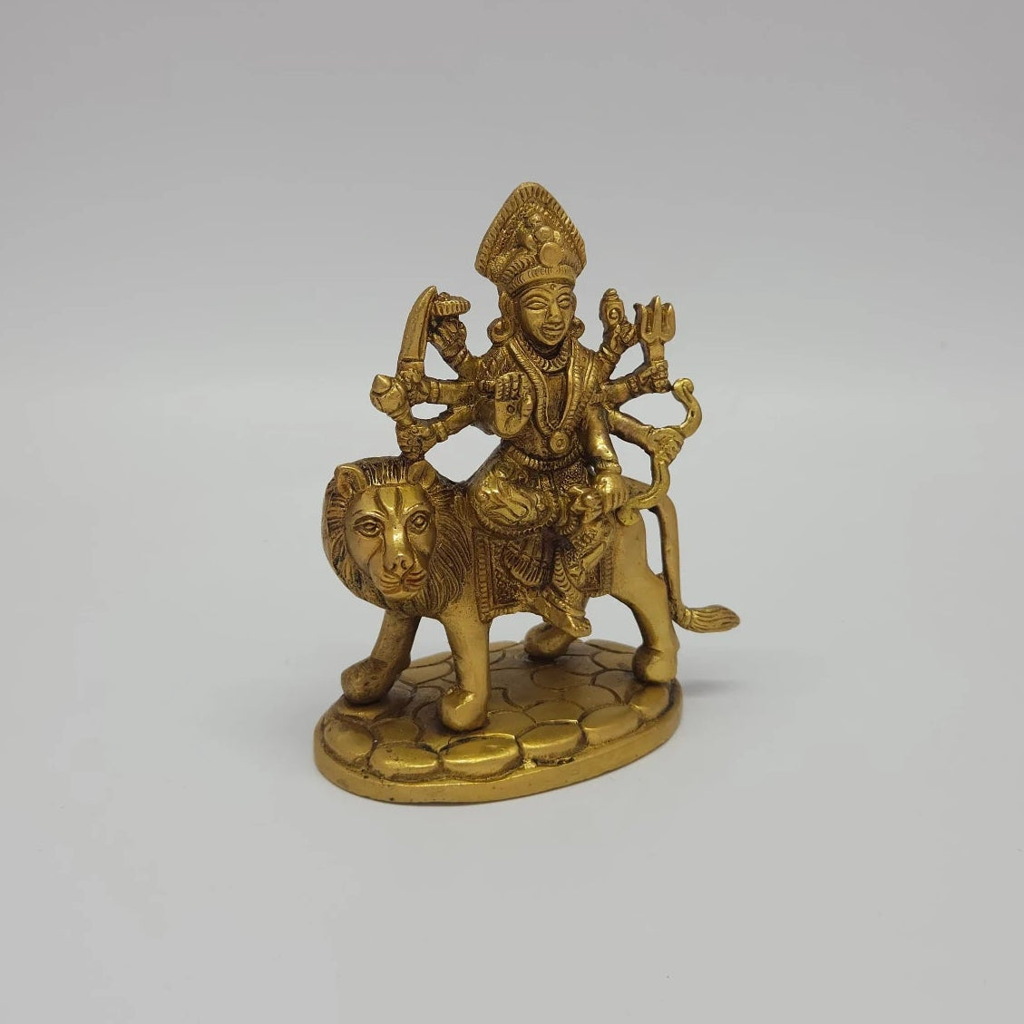 Right 45-degree perspective highlighting the fine features of the Goddess face, the raised Abhaya blessing hand, and the lion's forward stance