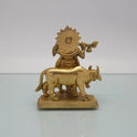 Rear view showcasing the detailed back structures of the sunburst halo crown, cow's torso, and the raw antique brass texture of the 825g idol.