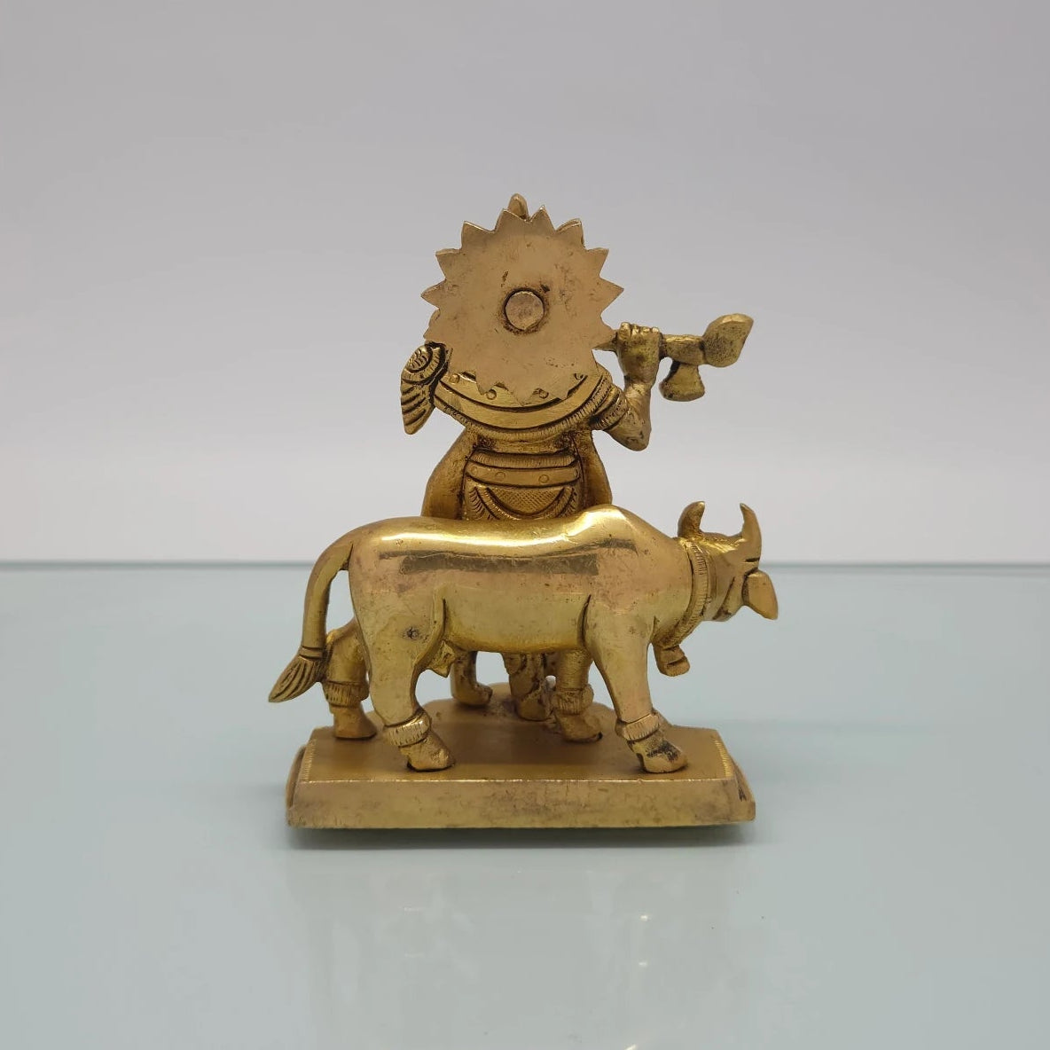 Rear view showcasing the detailed back structures of the sunburst halo crown, cow's torso, and the raw antique brass texture of the 825g idol.