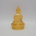 Rear view showcasing the detailed robe texture and brilliant gold finish of the 1.1kg decorative brass Buddha sculpture