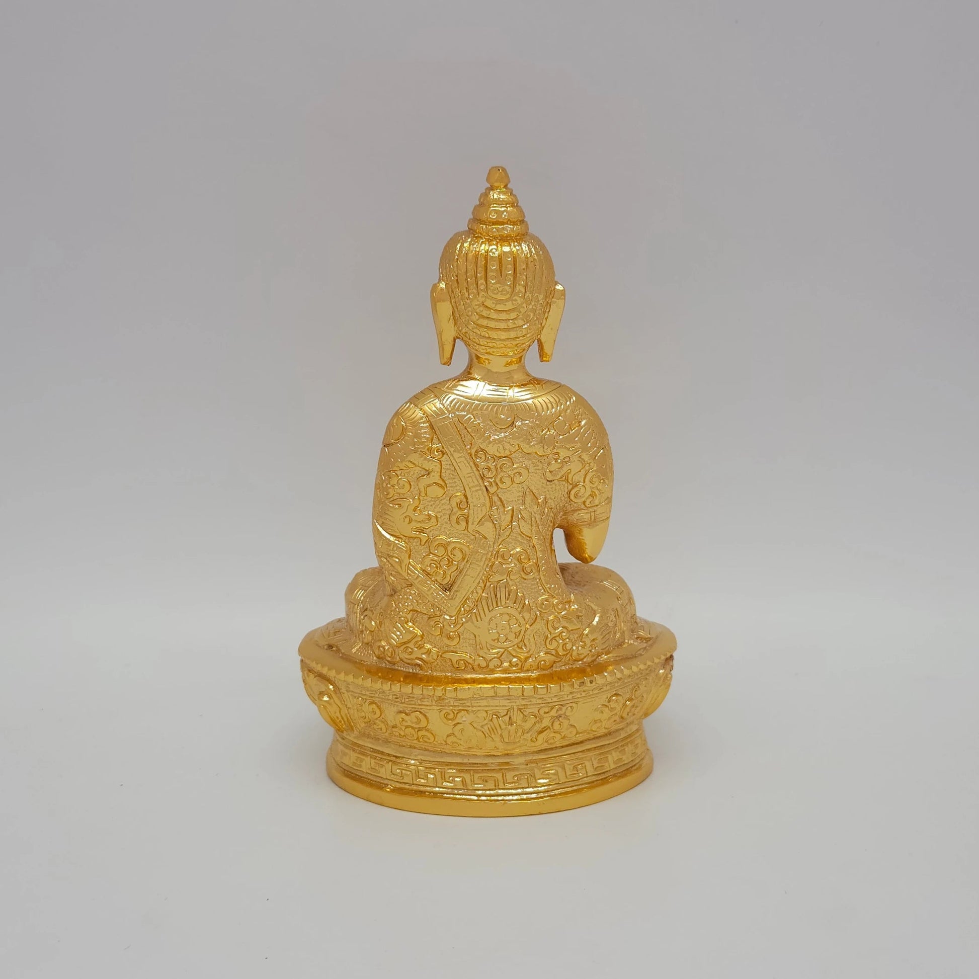 Rear view showcasing the detailed robe texture and brilliant gold finish of the 1.1kg decorative brass Buddha sculpture