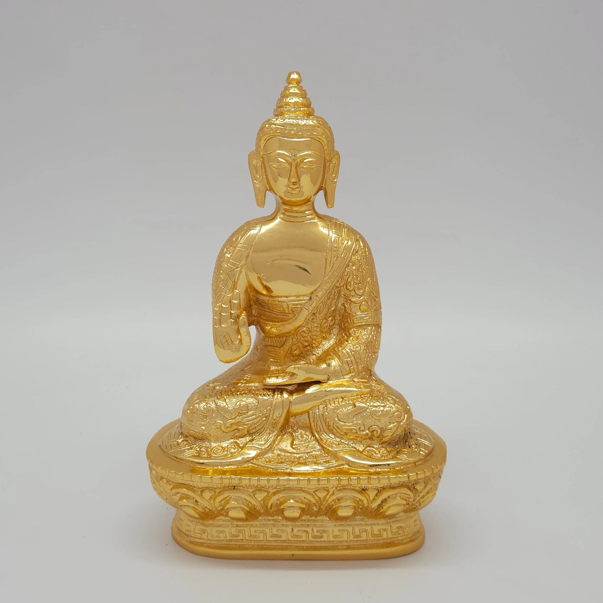 Front view of the 17cm / 6.7-inch premium gold powder-coated brass Shakyamuni blessing Buddha statue on an engraved base