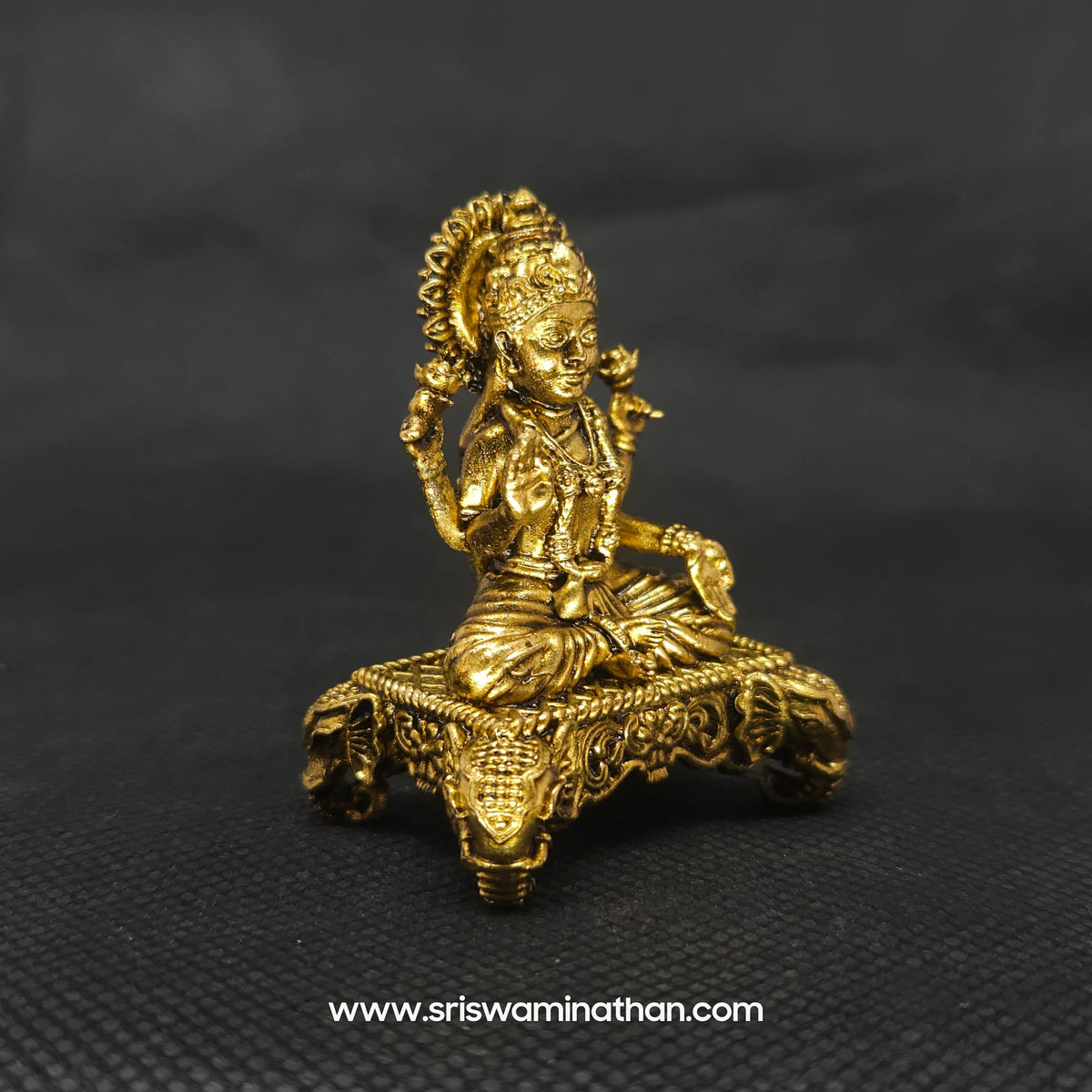 Three-quarter front right perspective view of the 2 inch premium brass Lakshmi statue highlighting the high-detail chiseled floral vine scrollwork requiring no hard washing.