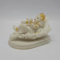 Front right perspective of the 3-inch baby Krishna statue demonstrating the clean details of the leaf veins and the solid pedestal.