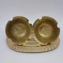 High angle top-down view displaying two 4.9 inch floral engraved brass bowls arranged symmetrically on a tray to practically demonstrate interior design variations