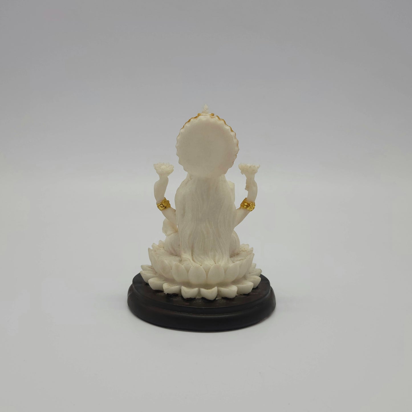 Full back view of the 4.3-inch Lakshmi statue demonstrating the smooth circular halo behind her crown and the rounded contours of the base pedestal.