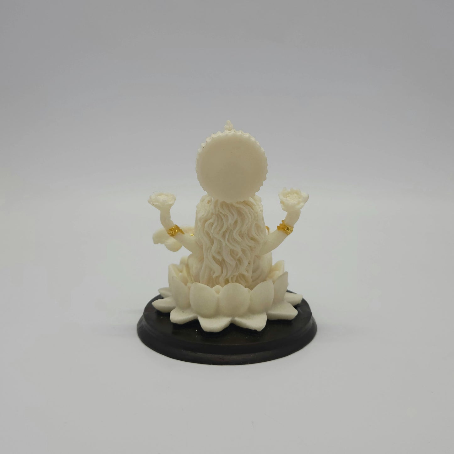 Full back view of the 4-inch Saraswati statue demonstrating the smooth circular halo behind her crown and the rounded contours of the black base pedestal.