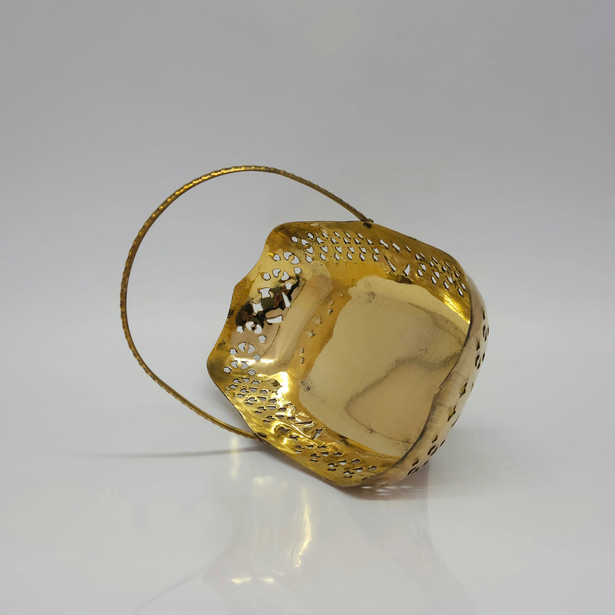 High angle top-down view looking into the 7 inch folding brass basket bowl highlighting the smooth high-gloss mirror polished interior floor