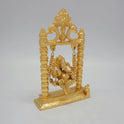 Three-quarter right angle view of the anti-tarnish gold powder-coated brass swinging Ganesha idol showing the depth of the temple pillars.
