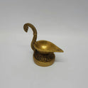 Three-quarter high angle view of the 480g heavy brass handheld oil lamp showing the inside of the 5cm wide single wick oil basin.