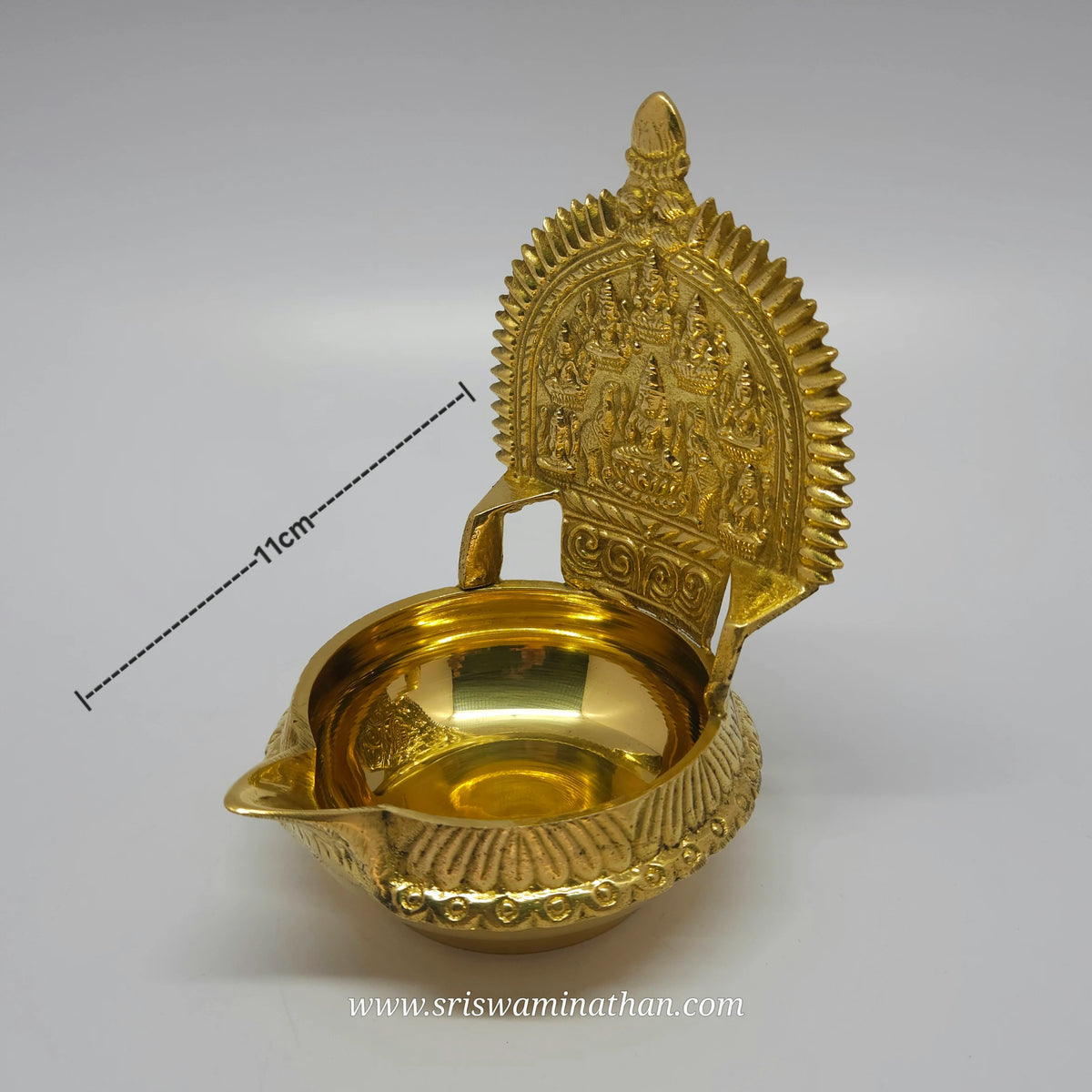 Three-quarter front right perspective view of the brass Ashtalakshmi deepam highlighting the deep 150ml capacity basin with depth measurement marker.