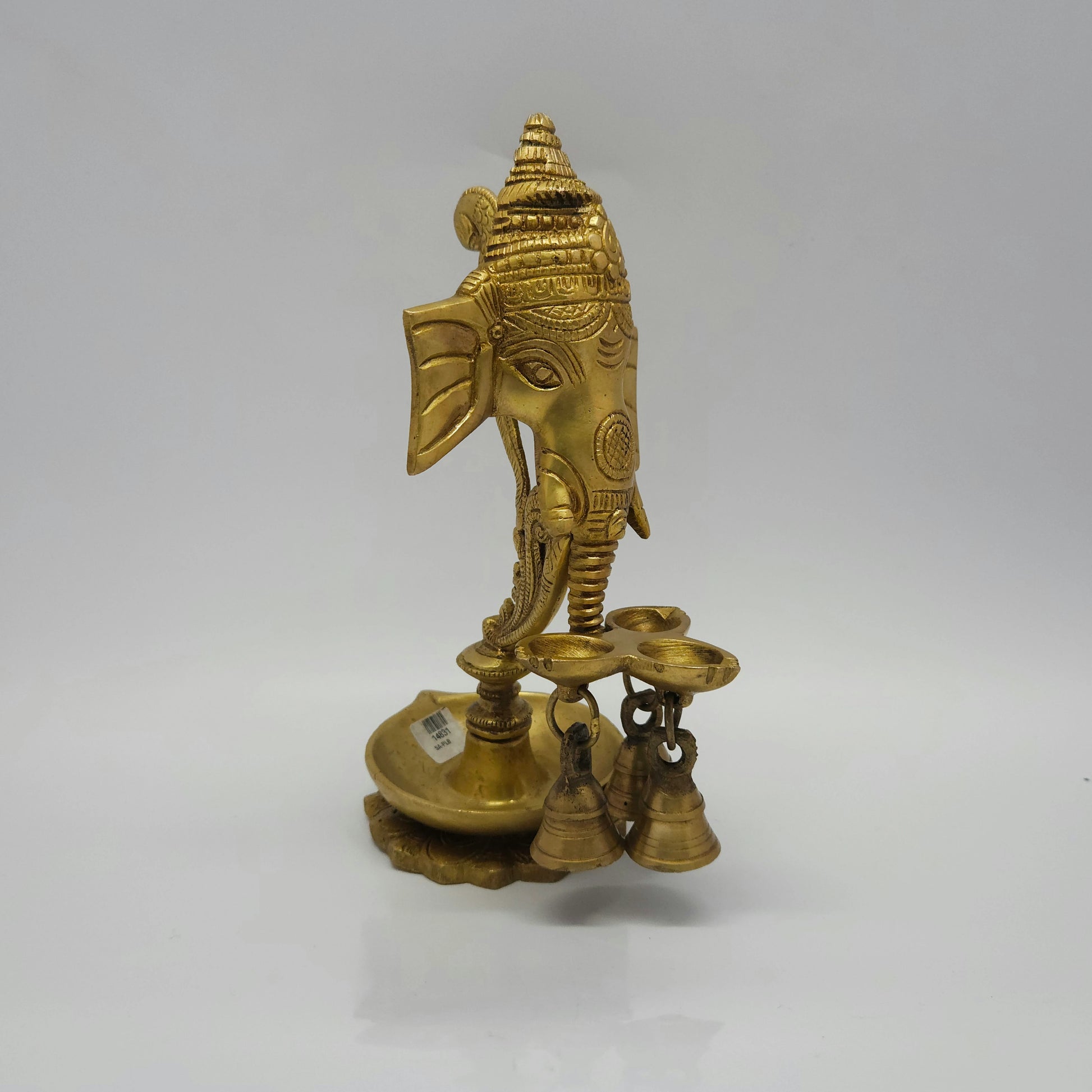 Side profile view of the 650g brass Ganesha wall hanging oil lamp showing the projection depth of the diya step and the hanging bells.