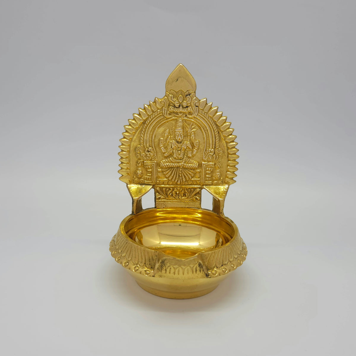 Straight front view of the 15cm brass Karumbu Kamatchi Kubera Nalla Vilakku showcasing the detailed seating posture and high-gloss polish by Sri Swaminathan and Co.