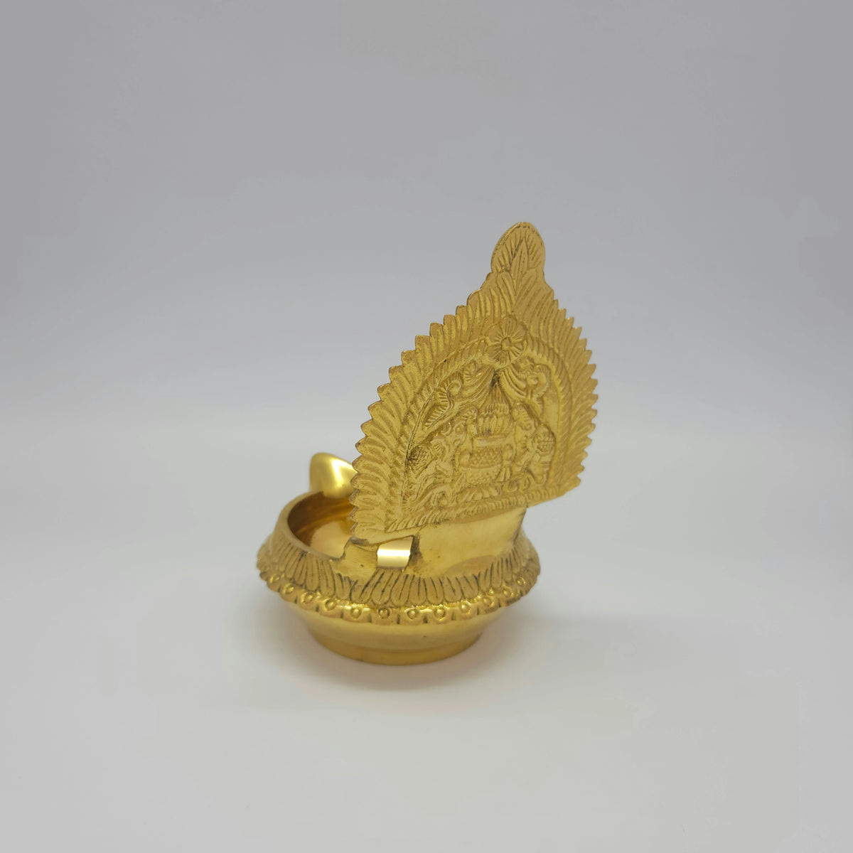 Three-quarter rear left view of the 450g brass Kubera Gajalakshmi lamp showcasing the two elephants, kalasa kumbam, and ornated flower arch.