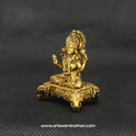 Three-quarter front left perspective view of the 5cm solid brass Lakshmi icon on a four-legged pedestal showing a durable dust-resistant surface needing only gentle liquid wipes.