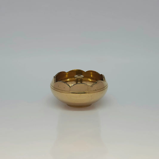 Straight front view of a single solid brass lotus border center-wick diya showcasing its scalloped rim design by Sri Swaminathan and Co.