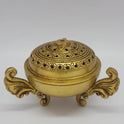 Three-quarter front perspective view of the premium brass peacock dhoop dhani showing the detailed perforated floral mesh lattice layout on the lid.
