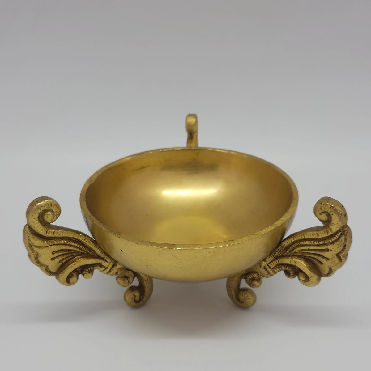 Front view of the premium brass peacock dhoop dhani shown open with the lid removed to highlight the polished inner combustion basin and winged base