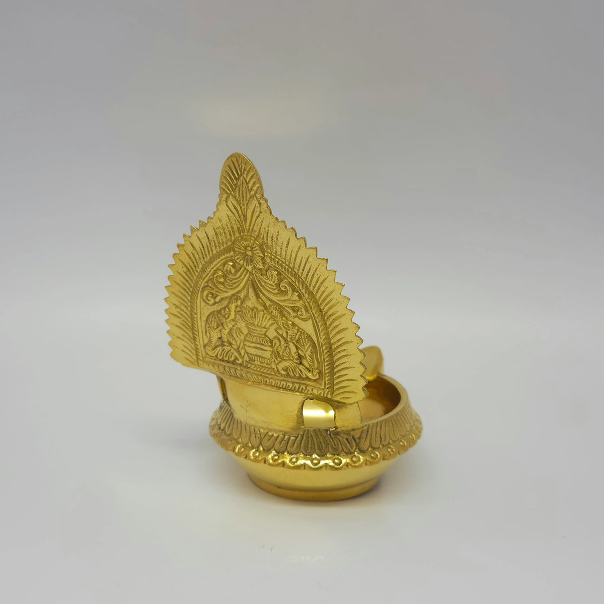 Side rear perspective view of the 450g brass Perumal Namam lamp showcasing the structural back details of the two elephants and kalasa kumbam arch.