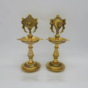 Straight front view of a single solid brass 25cm standing kuthu vilakku embossed with the divine Shanku conch backframe by Sri Swaminathan and Co.