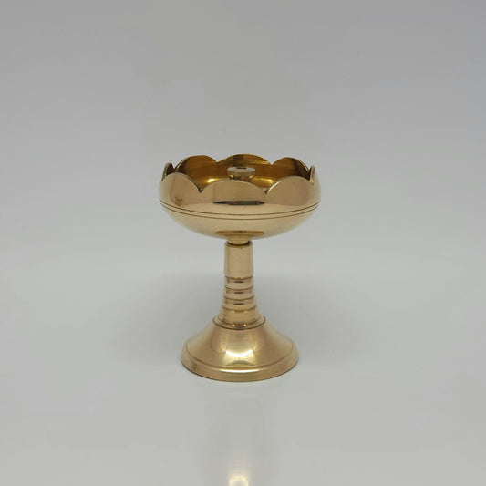 Straight front view of a single solid brass Akhand Jyot tall tulip diya showcasing its elevated pillar stem base by Sri Swaminathan and Co.