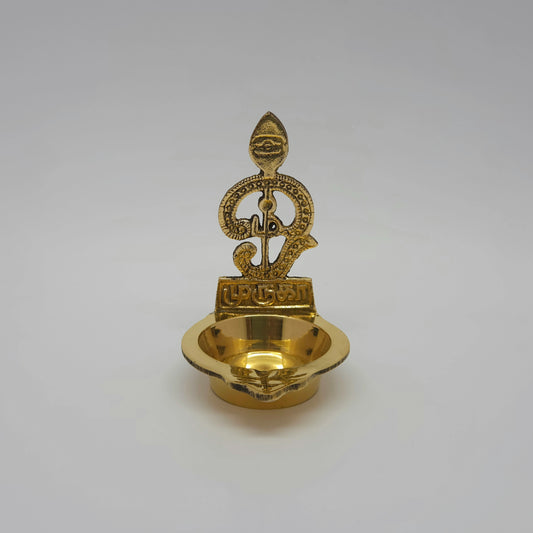 Straight front view of a single brass Tamil Om Vel Murugan altar diya showcasing the detailed pearl dot design and clean script highlights by Sri Swaminathan and Co.