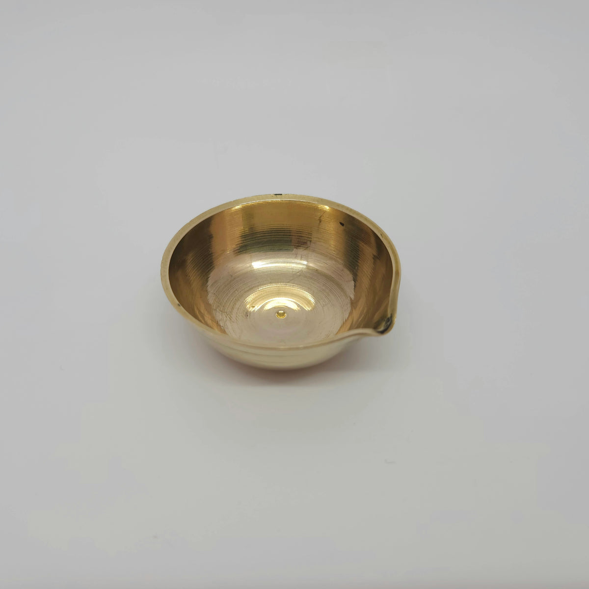 Three-quarter perspective view of the 20g mini brass agal cup lamp showcasing the single-spout wick nose projection