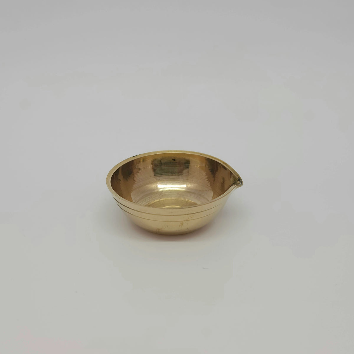 Straight front view of a single solid brass classic mini altar agal vilakku showcasing the parallel ring grooves along the base by Sri Swaminathan and Co.