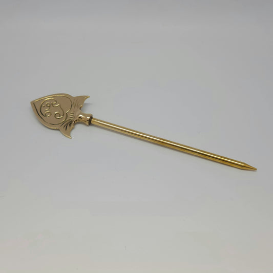Profile view of a single pure solid brass handheld Murugan Vel without a base lying against a clean white background.