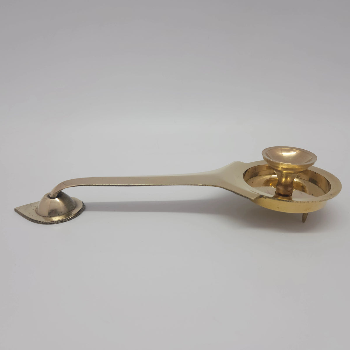 Side view of pure brass long handle camphor arati spoon showing the bottom legs for ground clearance and the elevated center kumizh cup