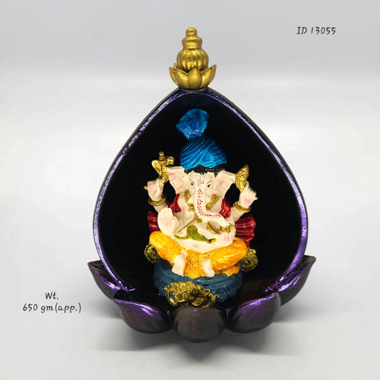 Front view of an 18.5cm detachable resin Ganesha statue nested inside a metallic purple lotus leaf canopy frame by Sri Swaminathan and Co