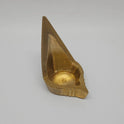 Three-quarter front right perspective view of the eight centimeter high brass mada vilakku highlighting the deep oil cup basin and pointed front wick groove