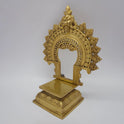 Three-quarter front right perspective view of the eleven inch brass prabhavali singhasan throne demonstrating the polished rectangular platform and chiseled flame archway border.