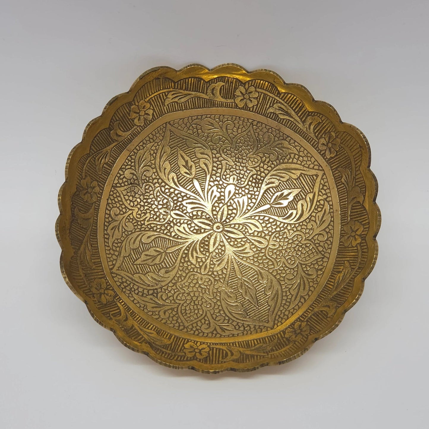 Straight top down view of the 15cm brass bowl highlighting the crisp engraved six-petal center star and continuous leaf vines
