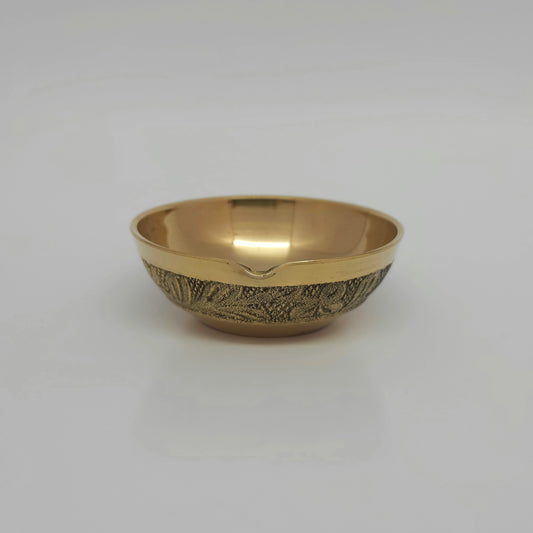 Straight front view of a single solid brass floral engraved border altar agal vilakku showcasing the continuous traditional patterns by Sri Swaminathan and Co.