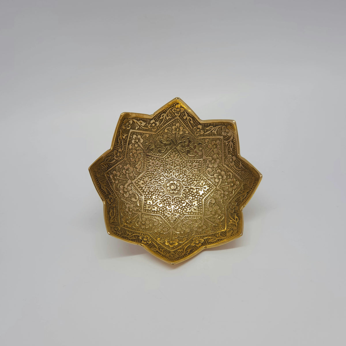Direct top-down view looking into the 10cm floral lotus blossom brass bowl highlighting the intricate textured leaf matrices engraved on the interior basin