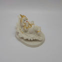 Angled back right look of the white poly-marble child Krishna figurine showcasing the smooth texture and the gold highlights on his crown.
