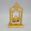Full back view of the 7.5 inch gold powder-coated solid brass Ganesha on a swing demonstrating the clean contours of the archway backing.