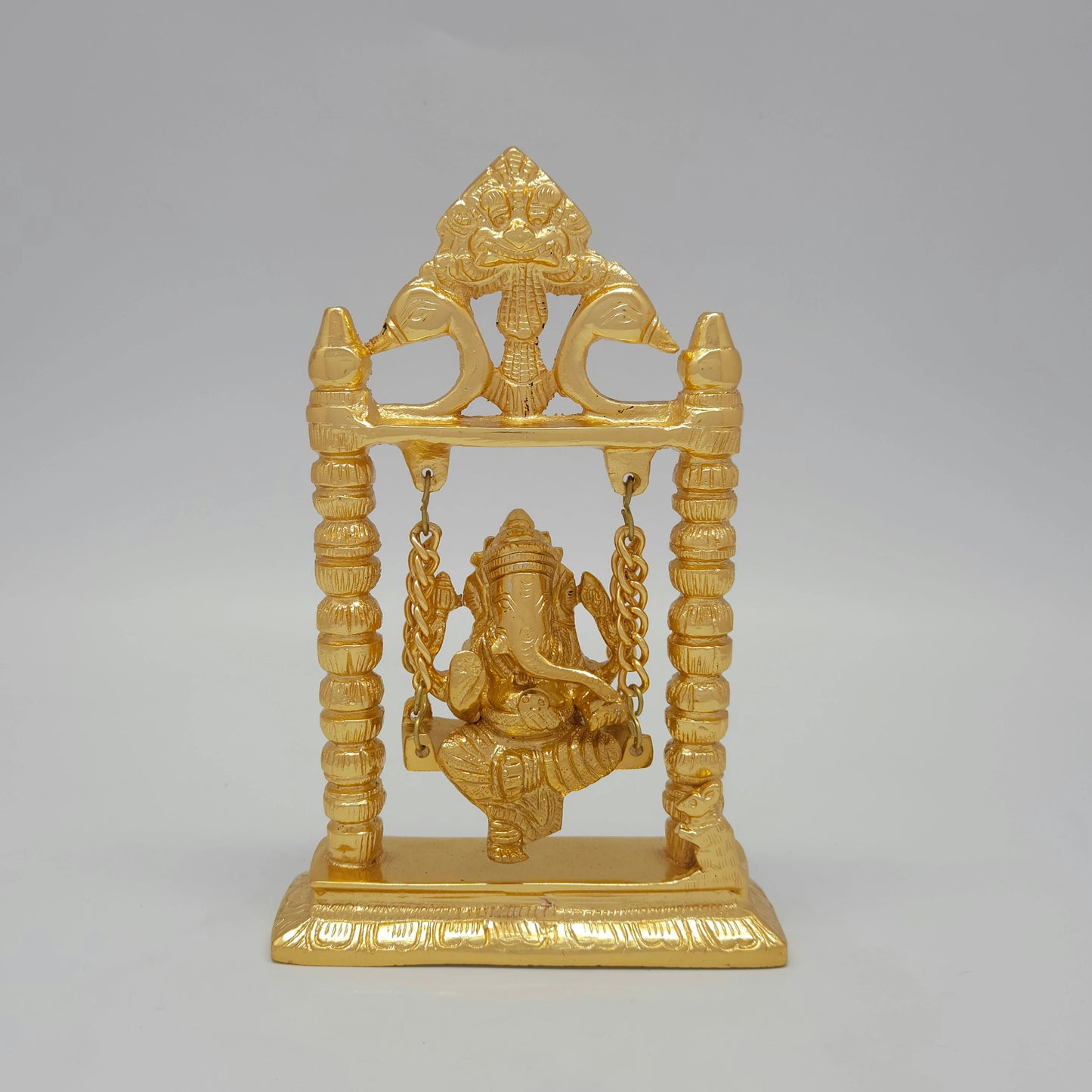 Front view of a 19cm premium gold powder-coated solid brass Ganesha statue on a hanging swing by Sri Swaminathan and Co