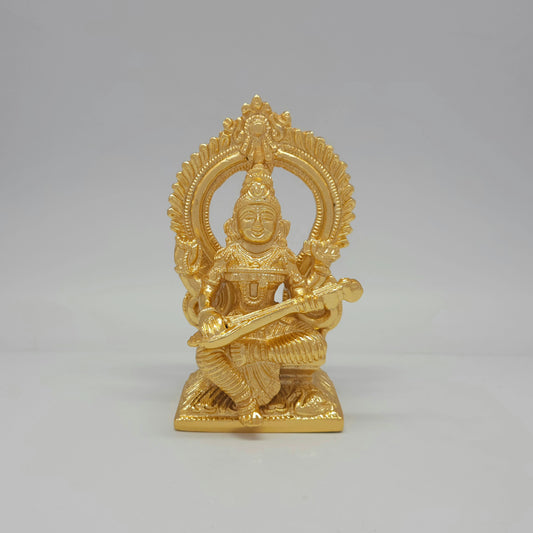 Front view of a 14.5cm premium gold powder-coated solid brass Goddess Saraswati statue playing a veena with a traditional halo arch by Sri Swaminathan and Co.