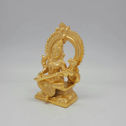 Left three-quarter angle view of the anti-tarnish gold powder-coated brass Saraswati idol showcasing the fine details of the throne base.
