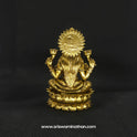 Direct straight back view of the solid brass seated Lakshmi statue with Akshaya Patram demonstrating the detailed rear surface of the sunburst halo crown and back hair arrangement.