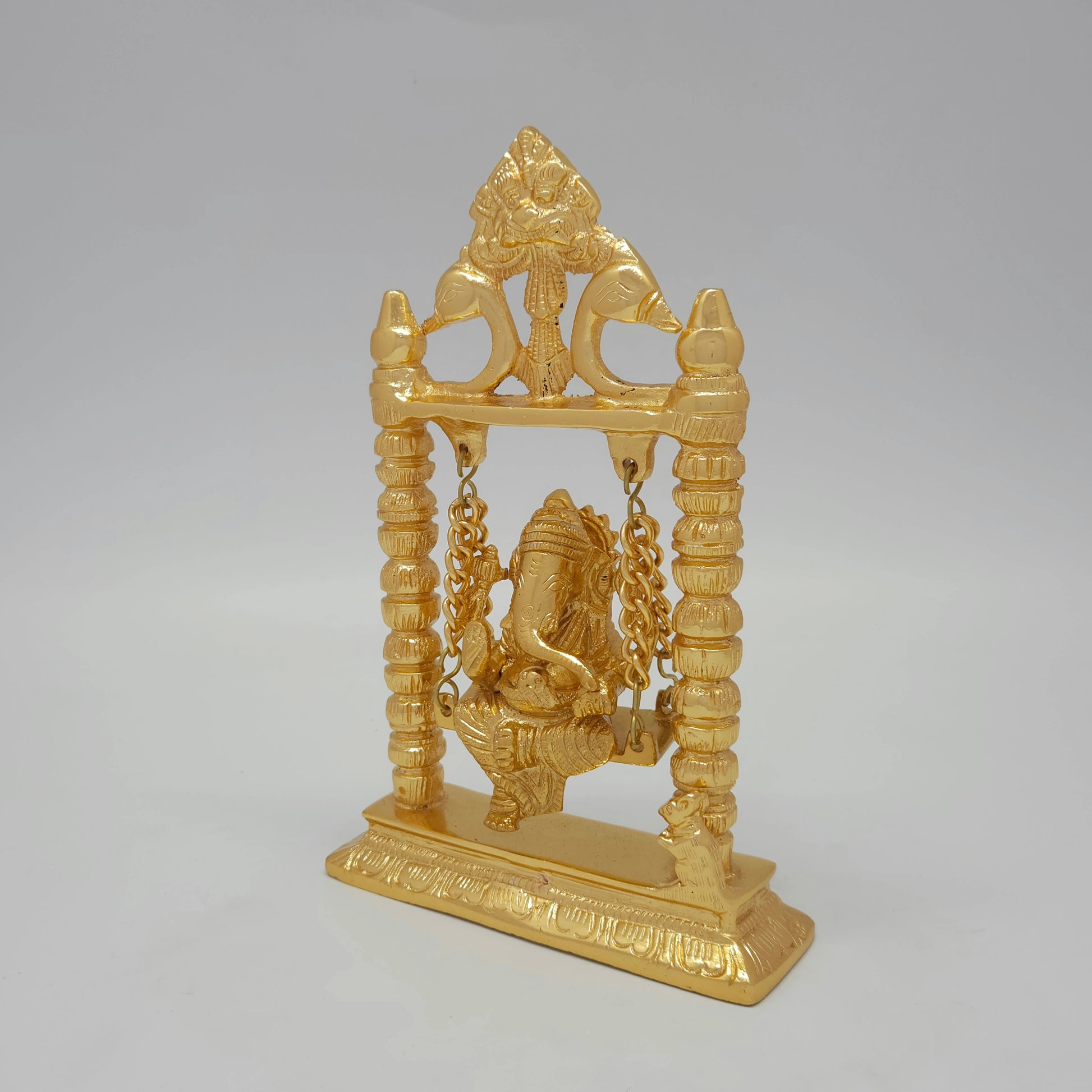 Three-quarter left perspective of the 1.06 kg gold-colored powder-coated brass Vinayagar swing statue highlighting the sturdy rectangular base plate.
