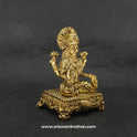 Three-quarter front right perspective view of the two and a half inch brass Lakshmi statue highlighting the gorgeous crown and the detailed gold coins showering from her palm.
