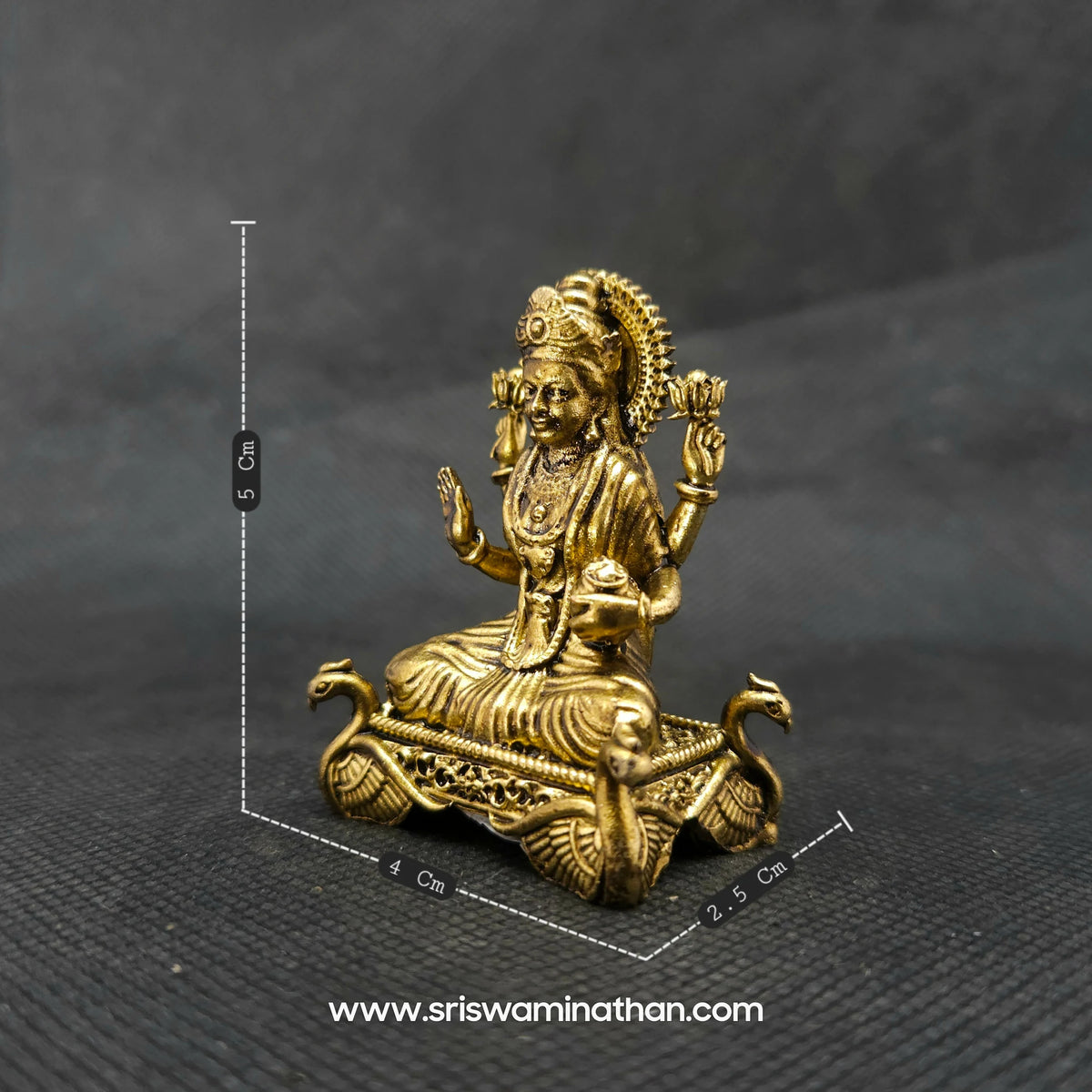 Front perspective measurement photo of the two and a half inch brass Lakshmi statue on a hamsa throne next to a scale demonstrating its compact micro altar dimensions