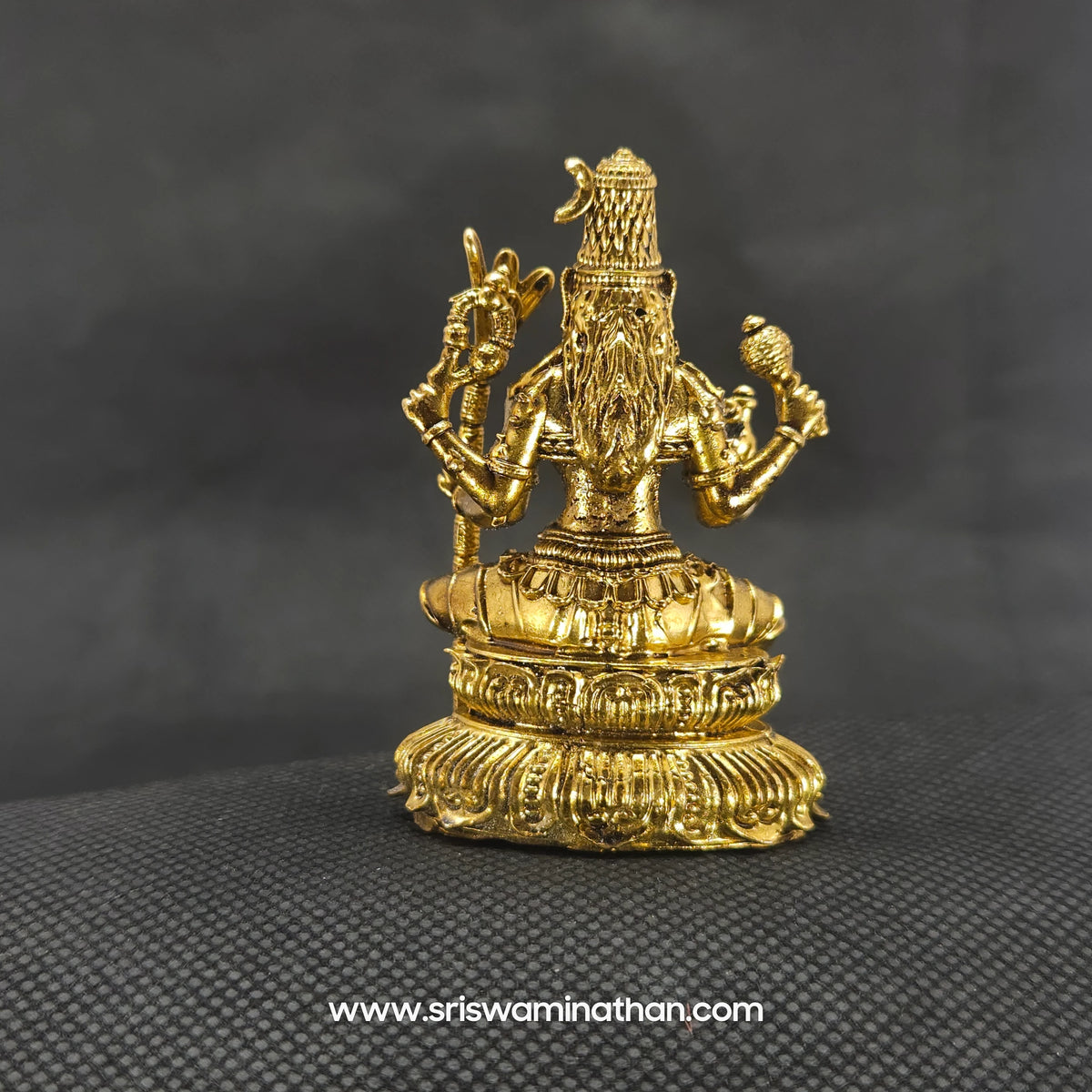 Direct straight back view of the solid brass seated Lalitha Tripura Sundari statue demonstrating the detailed rear surface of the halo crown and back hair arrangement